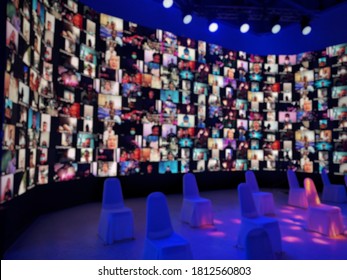Blur large LED screen show many people's faces join big online event or virtual reality live conference. Video conference, Work from home, Social distancing, New normal event production. 