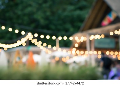 Blur The Lights On The Beach Restaurant In Siracha, Thailand. Blurred Cafe Background With Bokeh. Bright Sea View. Abstract Blur Of Coffee Cafe Shop.orange ,red, Light.