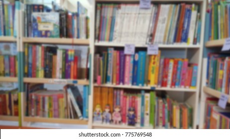 Blur Of Many Children's Books On Small Bookcases For Kids Learning And Loving Reading Books In Their Own Library. Kids's Storybook For Reading Before Bedtime Story-time Concept.