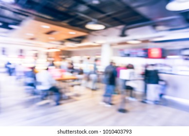 Blur Modern Hipster Open Coffee Shop, Self-serve Bakeries In USA. Long People Sit And Stand Queuing Behind Stanchion Barriers Check-out Counter. Wall Mount Led Menu Board Digital Signage. Vintage Tone