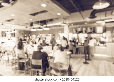 Blur Modern Hipster Open Coffee Shop, Self-serve Bakeries In USA. Long People Sit And Stand Queuing Behind Stanchion Barriers Check-out Counter. Wall Mount Led Menu Board Digital Signage. Vintage Tone