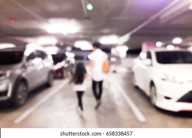 Blur Of Mother And Daughter Walking Their Own Car In The Parking Lot In The Shopping Mall At Night.