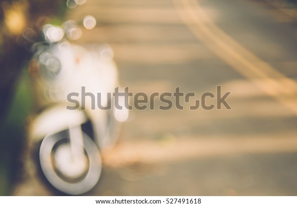 Blur motorbike on road abstract background. Copy\
space of travel adventure and transport concept. Vintage tone\
filter color style.