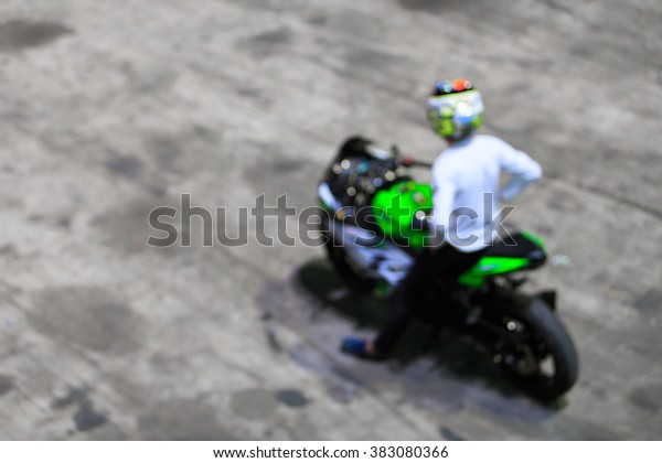 Blur Motorcycle at the starting line getting ready\
to race