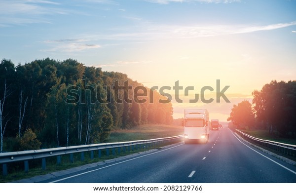 Blur move effect Truck with\
container on highway with sun light, concept cargo transportation.\

