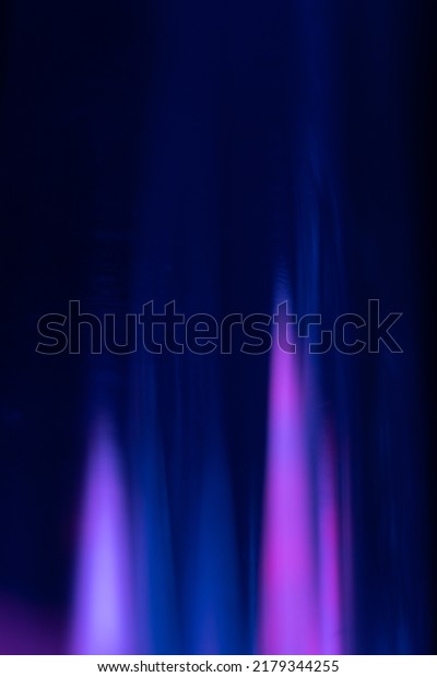 Blur neon glow. Color light flare. Cyber\
radiance. Defocused ultraviolet navy blue pink purple rays glare on\
dark futuristic abstract\
background.