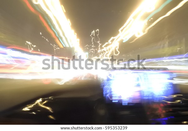 Blur neon light line on street view with\
monitor screen at night of car by drunken man. Abstract of this\
image is drunkenness and\
dangerous