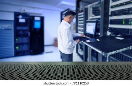 blur network administrator in data center room and copy space - Powered by Shutterstock