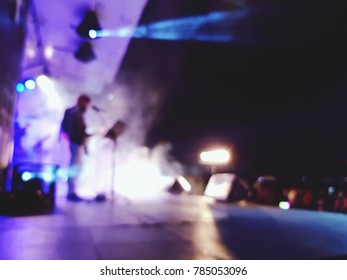 Blur Of Night Concert, Stage Performance With Lighting And Dry Ice Smoke Effect At Outdoor Free Concert  With Group Or Audience In Front Of The Stage