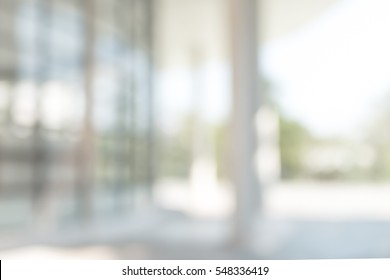 Blur office background building exterior view to lobby glass window wall with blurry light bokeh