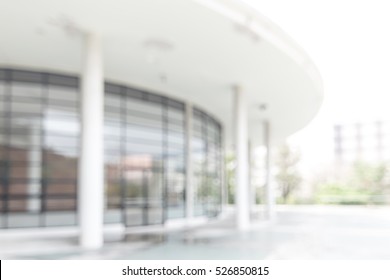 Blur Office Building, Hospital, Clinic Or School Background Exterior View Looking Out Toward To Empty Lobby And Entrance Doors And Glass Curtain Wall 