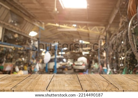 blur old garage interior with wooden table space for car service products advertising montage background