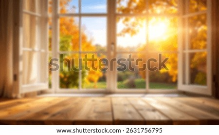 Blur Open window framing vibrant autumn foliage with warm sunlight streaming in