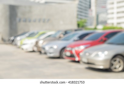 Blur Outdoor Car Park In The Official Place And The Hot Sun. Cars Parked In A Row. Blur And Abstract Background