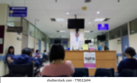 Blur Of Outpatients And Family Sitting To Meet A Doctor As Their Medical Appointment On Weekday At Examination Room In The Public Hospital, Thailand. Waiting To Meet A Doctor Concept.