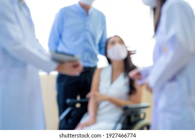 Blur The Patient Was Wearing A Mask And Listening To The Doctor To Explain Their Symptoms In The Hospital Lobby
