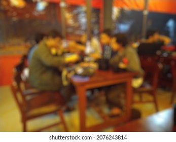 Blur People Eating At A Korean Bbq Restaurant