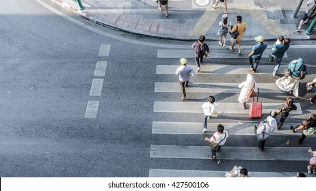 Blur People Are Moving Across The Pedestrian Crosswalk In The City Road (on Top View)