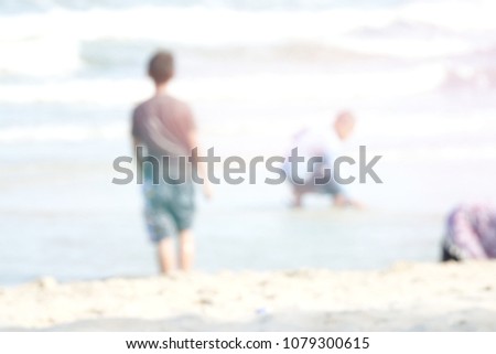 Similar – zwei erwachsene und ein kind in badebekleidung auf einem roller am meer. verschwommen