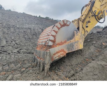 Blur Photo Of Backhoe Working By Digging Soil At Construction Site. Bucket Of Backhoe Digging Soil. Crawler Excavator Digging On Dirt. Excavating Machine. Earth Moving Machine. Excavation Vehicle.