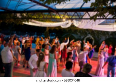 Blur Photo Of Crowd People Party Dance At Wedding Outdoor At Night.