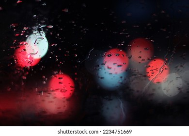 Blur photo of wet window glass exposed to light at night