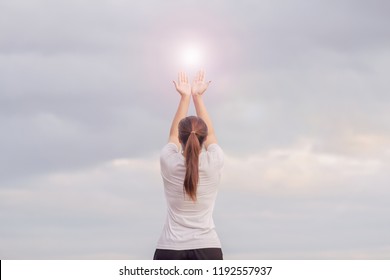 blur photo,The girl holds her hands above her head to the sky to seek the power of the fire of God to help her fulfill her promise and to pray to God for good luck.
Concept Faith in the power of God