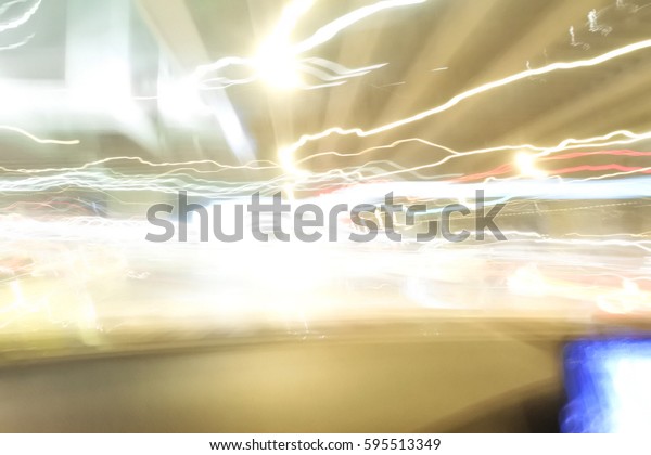 Blur picture of\
light line on road at night in drunker view. Concept of this\
picture is traveling by\
drunkenness.