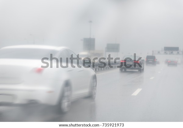 Blur Picture of traffic on the freeway during a\
storm. Heavy rain on a\
road