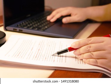 Blur Proofreading Paper And Computer Laptop On Table Under Lamp Light