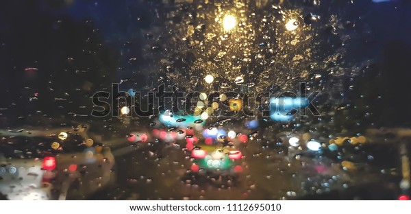 Blur\
Rain drops on car glass at evening on the\
street.