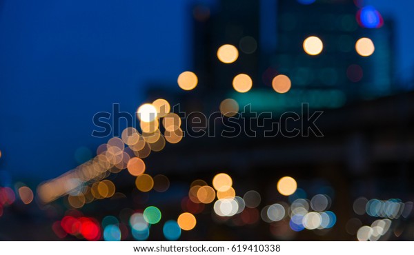 Blur road lamp and blur traffic cars\
light in the evening and blur building\
background.