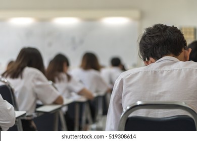 Blur School Background Back View University Students Writing Answer Doing Exam In Classroom