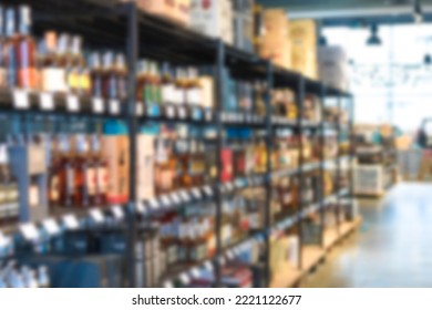 Blur shelves with wine bottles at liquor store as background with copy space. Many blurred bottles with alcohol - Shutterstock ID 2221122677