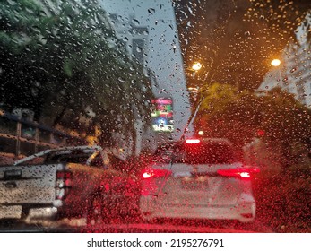 Blur shot of cars stuck in heavy traffic and heavy rain during rush hour on Monday morning in Bangkok, Thailand  - Powered by Shutterstock