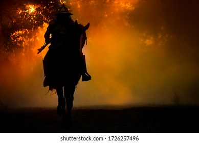 Blur Silhouette Of A Ancient Japanese Samurai Warrior In Armor On Horseback  Smoke Background.