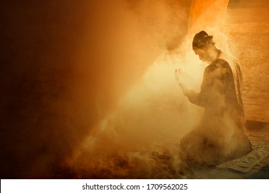 Blur  silhouette of muslim man having worship and praying for fasting and Eid of Islam culture in old mosque with lighting and smoke background             