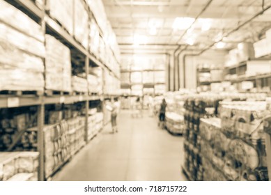 Blur stack of paper product (napkins, towels) and cleaning supplies floor to ceiling in large warehouse. Wholesale big box store US, customer shopping. Defocused distribution storehouse. Vintage tone - Shutterstock ID 718715722
