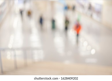 Blur Store With Bokeh Background. Silhouettes Of Business People In Blurred Motion Walking. Business People Walking In The Office Corridor.