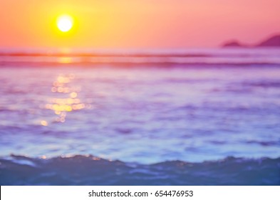 Blur Sunset Beach With Bokeh Light Wave Abstract Background.