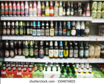 Blur Supermarket Sale Liquor, Whisky Or Alcohol Drink Section On Shelve Background, Many Alcohol Drink Bottles Sale On The Shelf In Supermarket, As Blurred Effect Background, Alcohol Drink Section.