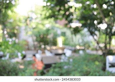 Blur of table chair under the tree. Used as a background image in a leisure concept.Abstract blur and defocused buffet restaurant and coffee shop cafe exterior for background - Powered by Shutterstock