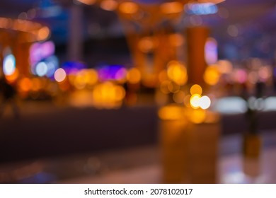 Blur and texture of light in a shopping mall, silhouettes of people and multicolored highlights.