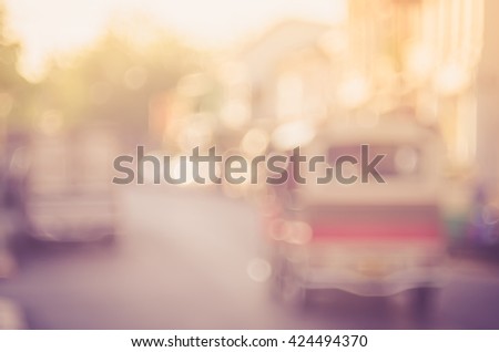 Blur traffic road with old building abstract background. Retro color style.