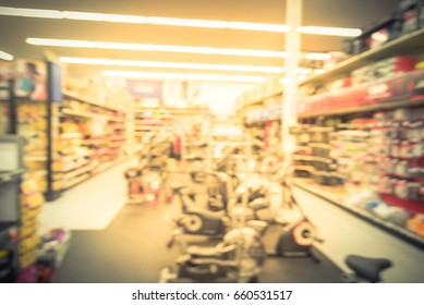 Blur Variety Of Fitness Equipment On Display At Sporting Goods Store In Houston, Texas, US. Defocused Pile Of Dumbbells, Weight, Strength Training, Stepper, Cardio Machines, Gym Service. Vintage Tone.