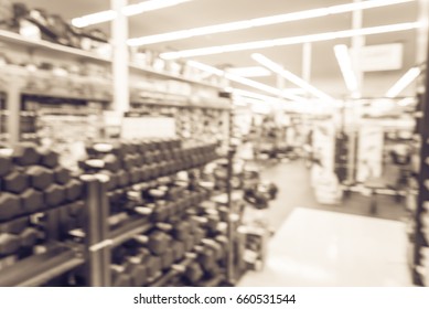 Blur Variety Of Fitness Equipment On Display At Sporting Goods Store In Houston, Texas, US. Defocused Pile Of Dumbbells, Weight, Strength Training, Stepper, Cardio Machines, Gym Service. Vintage Tone.