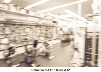 Blur Variety Of Fitness Equipment On Display At Sporting Goods Store In Houston, Texas, US. Defocused Pile Of Dumbbells, Weight, Strength Training, Stepper, Cardio Machine, Gym Room. Customer Shopping