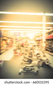 Blur Variety Of Fitness Equipment On Display At Sporting Goods Store In Houston, Texas, US. Defocused Pile Of Dumbbells, Weight, Strength Training, Stepper, Cardio Machines, Gym Service. Vintage Tone.