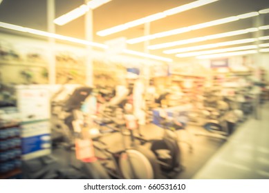 Blur Variety Of Fitness Equipment On Display At Sporting Goods Store In Houston, Texas, US. Defocused Pile Of Dumbbells, Weight, Strength Training, Stepper, Cardio Machines, Gym Service. Vintage Tone.