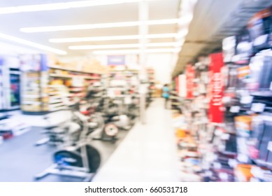 Blur Variety Of Fitness Equipment On Display At Sporting Goods Store In Houston, Texas, US. Defocused Pile Of Dumbbells, Weight, Strength Training, Stepper, Cardio Machine, Gym Room. Customer Shopping